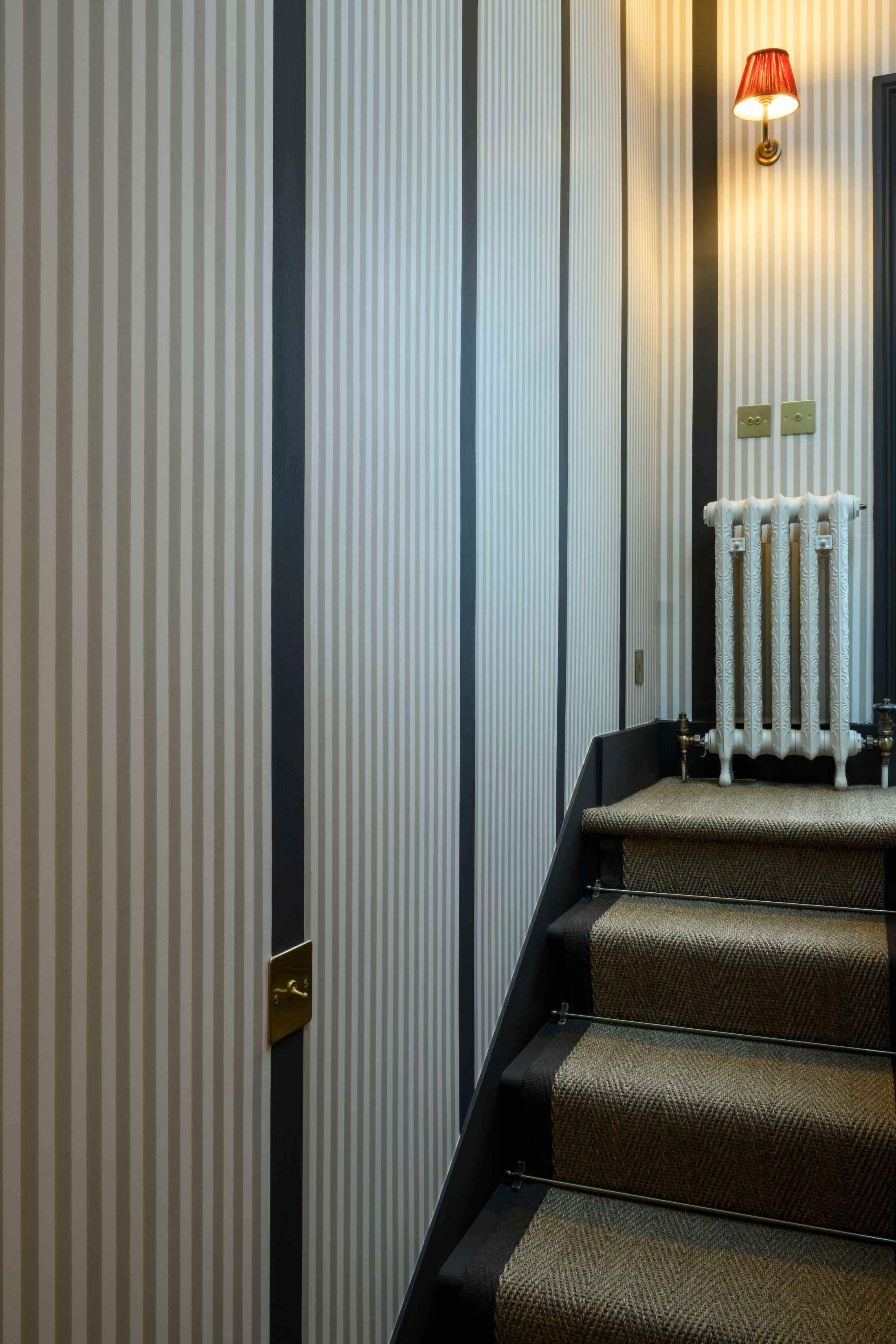 stairs-with-white-radiator-and-red-wall-light.jpg